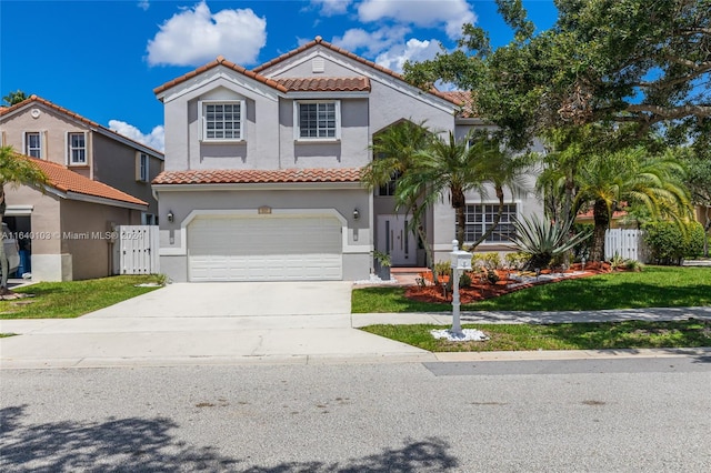 mediterranean / spanish-style house with a front lawn and a garage