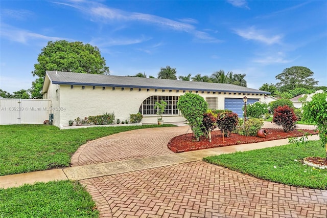 ranch-style home with a garage and a front yard