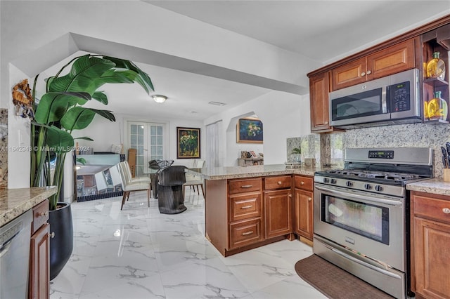 kitchen with decorative backsplash, kitchen peninsula, stainless steel appliances, and french doors