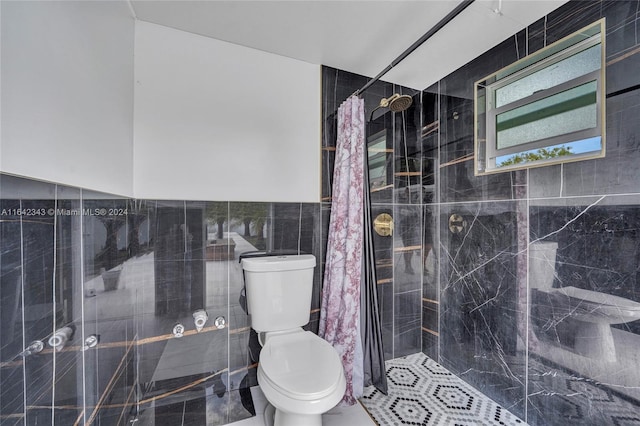 bathroom featuring walk in shower, tile walls, and toilet