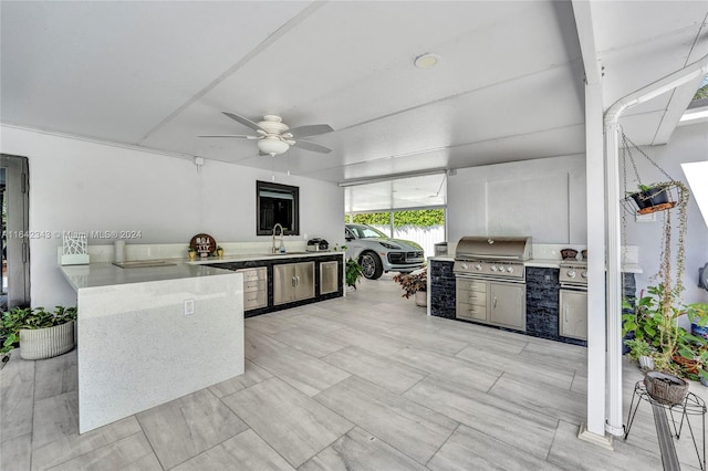 view of patio / terrace with area for grilling, ceiling fan, and sink