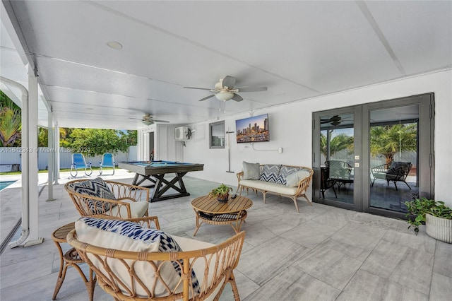 view of patio / terrace with a pool, outdoor lounge area, ceiling fan, french doors, and a wall mounted air conditioner