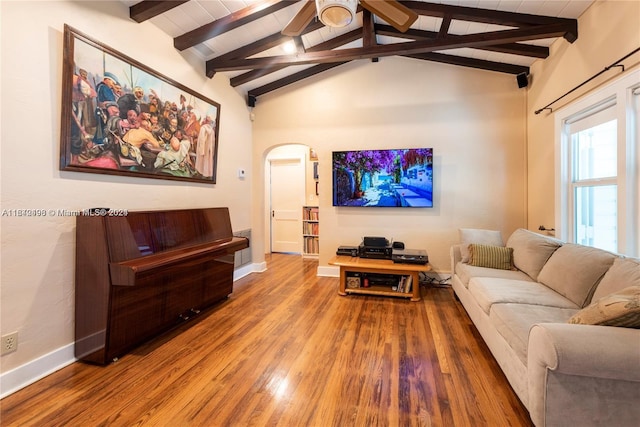 living room with vaulted ceiling with beams and hardwood / wood-style floors