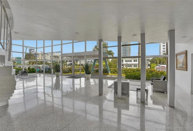 6484 Indian Creek Dr Unit 138, Miami Beach, FL 33141 - building lobby with a high ceiling and a wall of windows