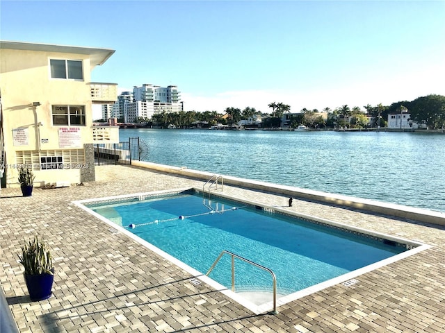 view of pool with a water view