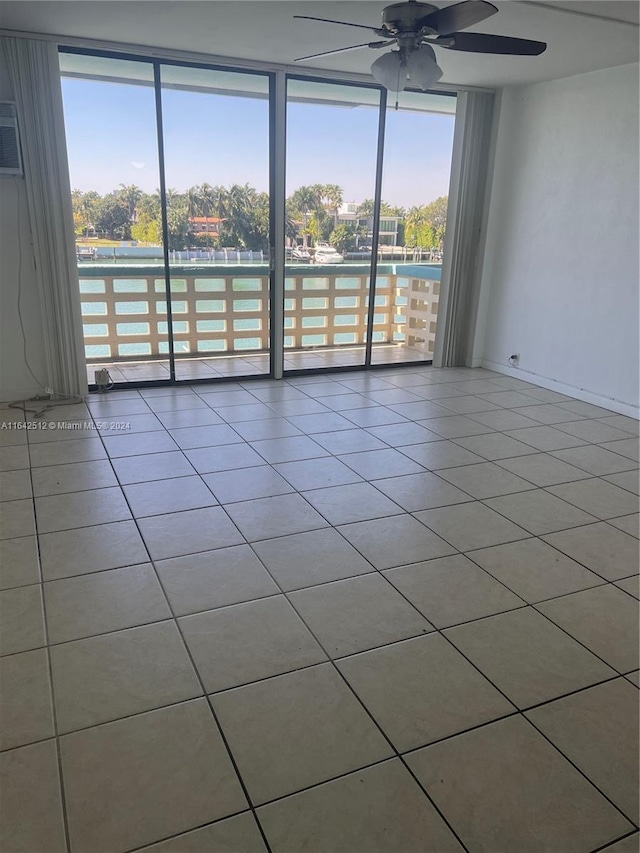 6484 Indian Creek Dr Unit 138, Miami Beach, FL 33141 - spare room featuring ceiling fan, tile patterned flooring, a wall of windows, and a water view