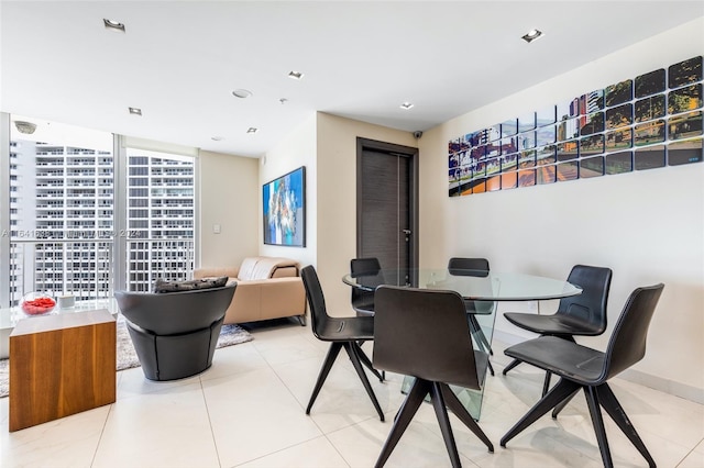 dining area with light tile patterned floors, floor to ceiling windows, and recessed lighting