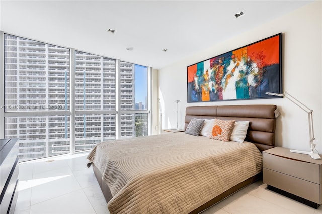 tiled bedroom featuring floor to ceiling windows