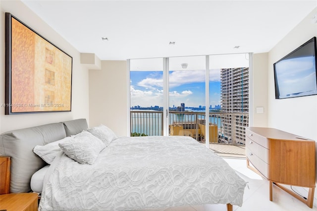 bedroom featuring access to outside, expansive windows, and light tile patterned floors