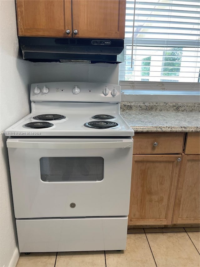 kitchen featuring light tile patterned flooring and electric range