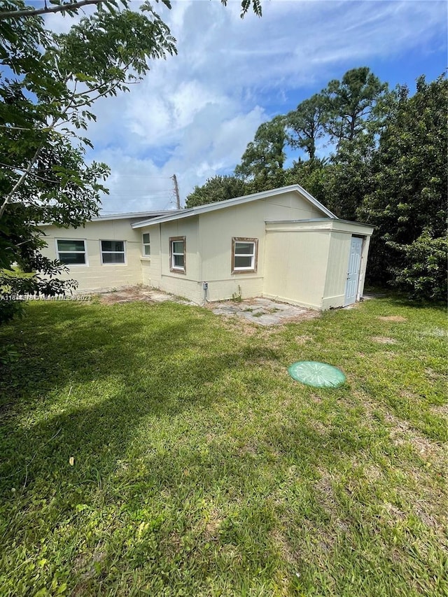 rear view of house with a lawn