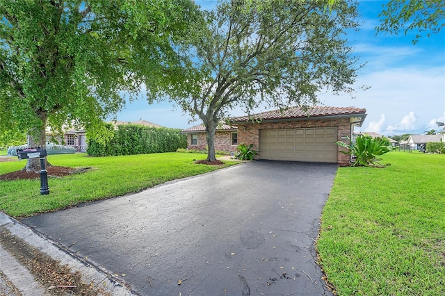 single story home with a front yard and a garage