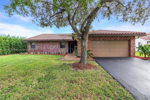 ranch-style home with a garage and a front lawn