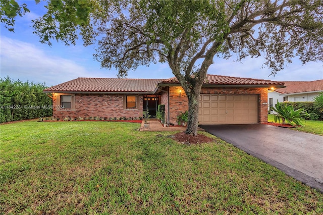 single story home with a front yard and a garage