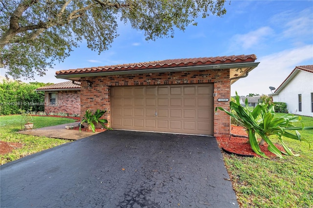 view of front of property with a garage and a front lawn