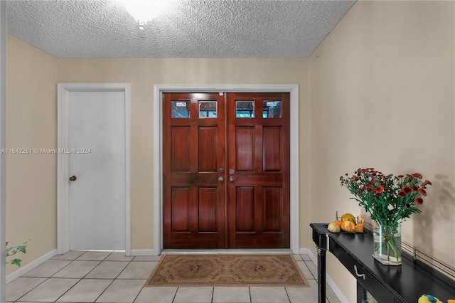 tiled foyer featuring a textured ceiling