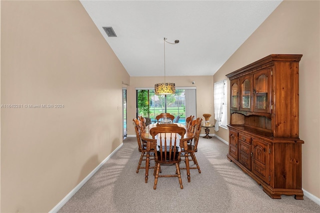 dining space featuring light carpet and high vaulted ceiling