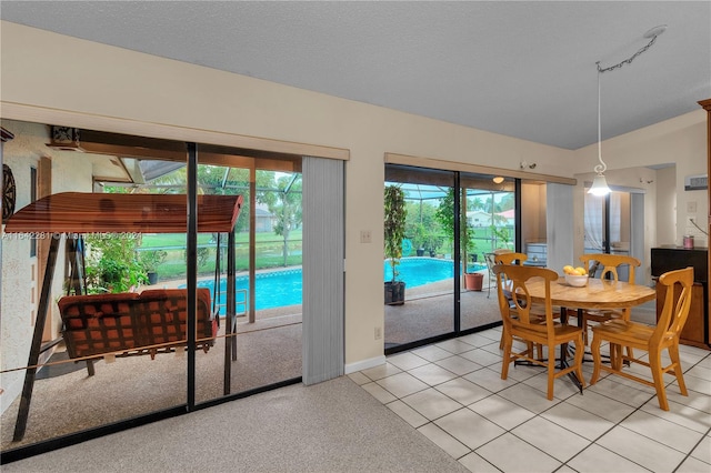 dining room featuring light tile patterned floors and a textured ceiling