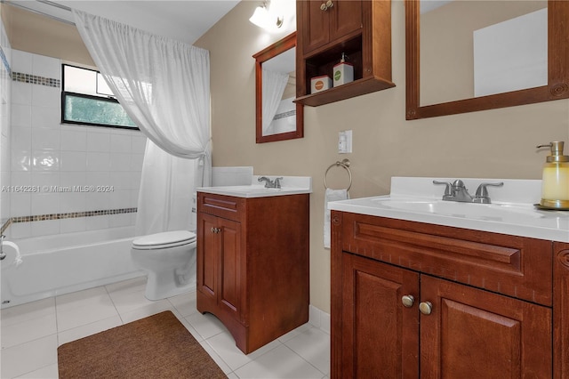 full bathroom featuring tile patterned flooring, vanity, toilet, and shower / bath combo with shower curtain