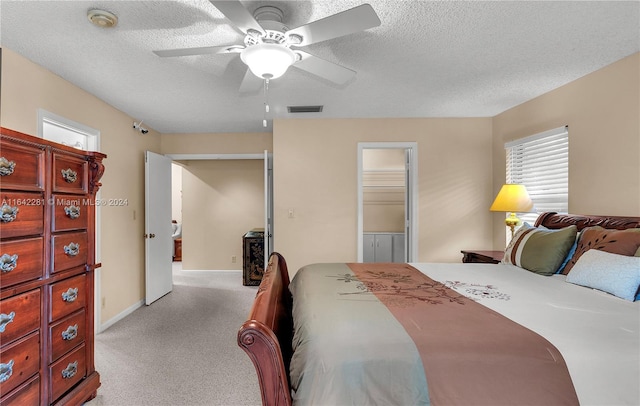 carpeted bedroom with ceiling fan, a textured ceiling, and a closet