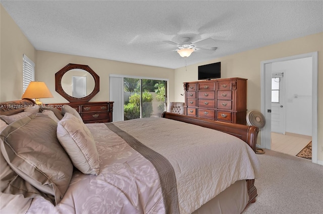 bedroom featuring light carpet, a textured ceiling, access to outside, and ceiling fan