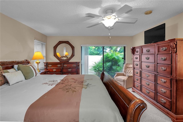 carpeted bedroom featuring ceiling fan, a textured ceiling, and access to outside