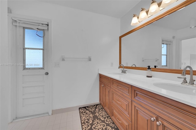 bathroom with tile patterned floors, vanity, and a wealth of natural light