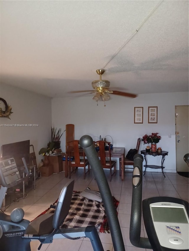 interior space with ceiling fan and tile patterned flooring