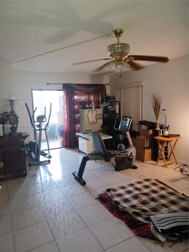 interior space with ceiling fan and tile patterned floors