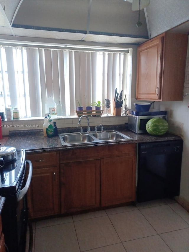 kitchen with sink, plenty of natural light, dishwasher, and light tile patterned floors