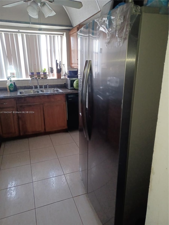 kitchen featuring ceiling fan, dishwasher, sink, stainless steel fridge, and light tile patterned flooring