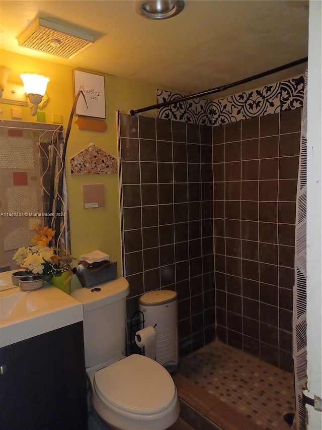 bathroom with toilet, vanity, and curtained shower