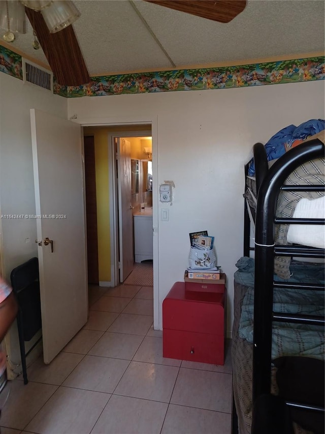 bedroom featuring tile patterned flooring and ensuite bath