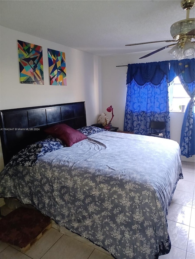 tiled bedroom with ceiling fan