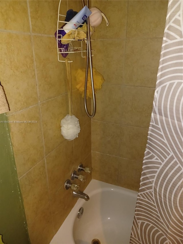 bathroom with shower / bath combination with curtain