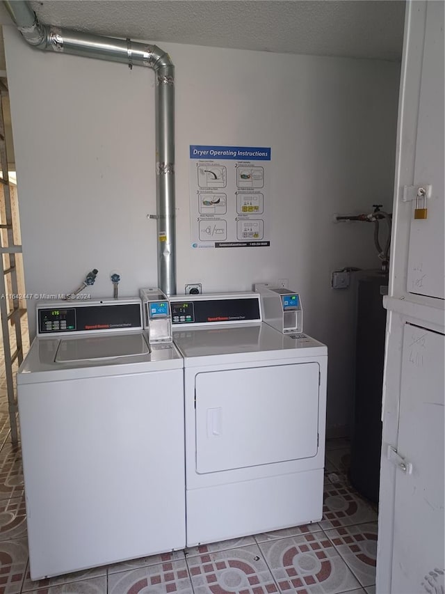 washroom featuring washing machine and clothes dryer and tile patterned floors