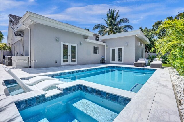 view of swimming pool featuring a patio, french doors, and an outdoor hangout area