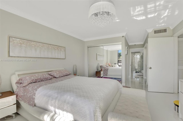 bedroom featuring a closet, a chandelier, and ornamental molding