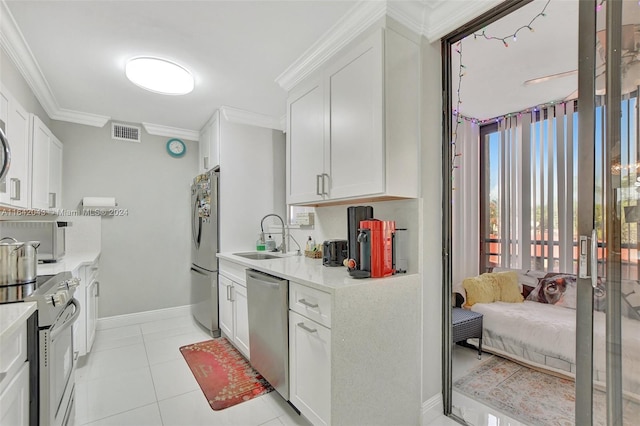 kitchen featuring white cabinetry, appliances with stainless steel finishes, sink, and light tile patterned flooring