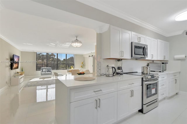 kitchen featuring crown molding, white cabinetry, light tile patterned flooring, and stainless steel appliances