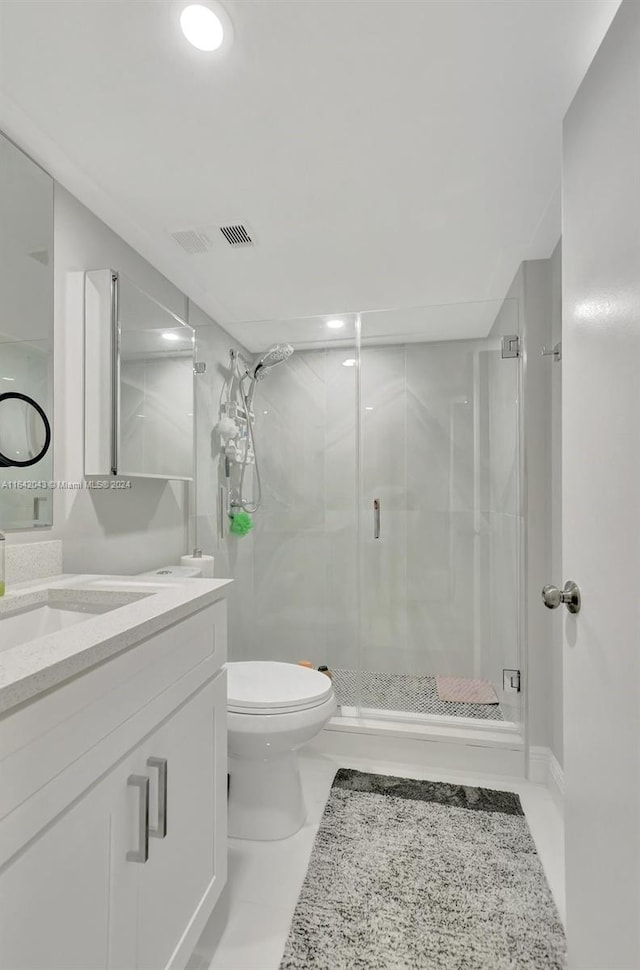 bathroom featuring tile patterned flooring, an enclosed shower, toilet, and vanity