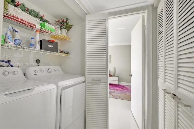 laundry room with tile patterned flooring, crown molding, and separate washer and dryer