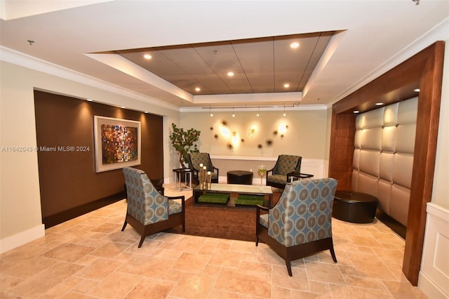 living room with crown molding, a raised ceiling, and light tile patterned floors