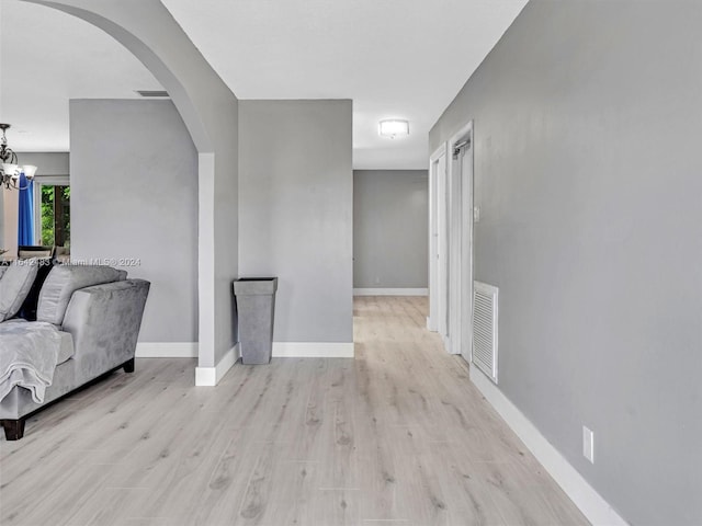 interior space with a chandelier and wood-type flooring