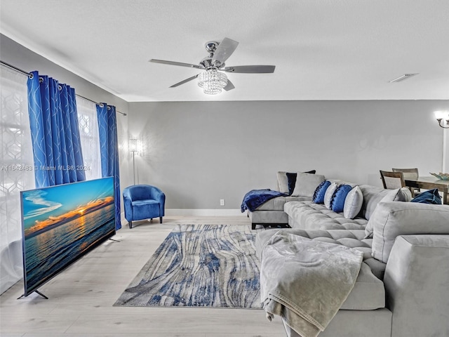 living room featuring ceiling fan and light hardwood / wood-style flooring