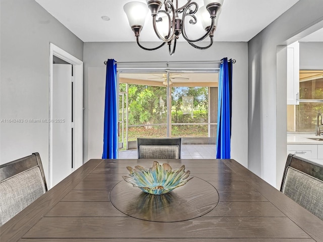 dining space with sink and a chandelier