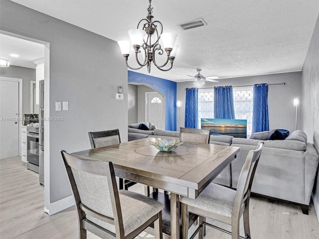 dining area featuring a textured ceiling, light hardwood / wood-style flooring, and ceiling fan with notable chandelier