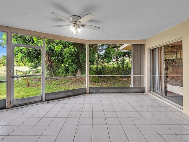 unfurnished sunroom with ceiling fan