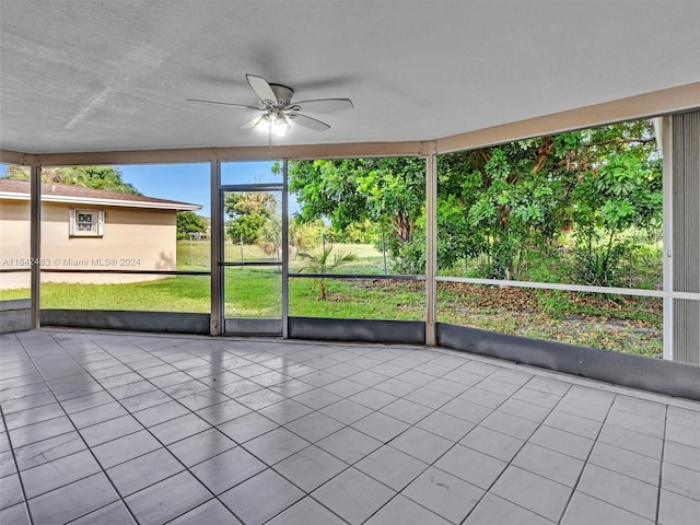 unfurnished sunroom featuring ceiling fan