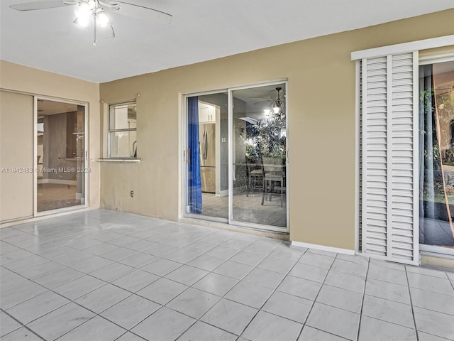 tiled spare room with ceiling fan